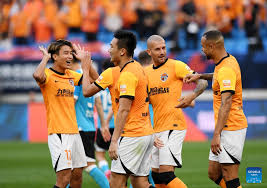 Qingdao Hainiu FC players celebrate goal